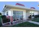 Charming condo featuring a cozy front porch with seating and well-maintained landscaping at 4355 Tahitian Gardens Cir # D, Holiday, FL 34691