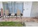 Inviting front porch area with two chairs, a table, a security door lock, and decorative tile flooring at 4355 Tahitian Gardens Cir # D, Holiday, FL 34691
