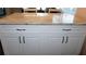 Kitchen island with white cabinets and hardware, and granite countertop at 4355 Tahitian Gardens Cir # D, Holiday, FL 34691