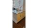 Kitchen island with white cabinets, dark hardware, and a marble countertop, bathed in light at 4355 Tahitian Gardens Cir # D, Holiday, FL 34691