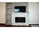 Stone fireplace with shelves and modern electric fireplace at 4355 Tahitian Gardens Cir # D, Holiday, FL 34691
