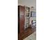 Cozy living room features a stone fireplace, built-in shelves, and a mounted television at 4355 Tahitian Gardens Cir # D, Holiday, FL 34691