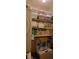 A storage room with shelves, containers, cleaning supplies, and laundry appliances on the side at 4355 Tahitian Gardens Cir # D, Holiday, FL 34691