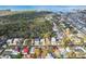 Expansive aerial view of a residential community near the coast, surrounded by lush trees and a waterway at 45 Gulfwinds W Dr, Palm Harbor, FL 34683