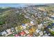 Expansive aerial view of a residential community near the coast, surrounded by lush trees and a waterway at 45 Gulfwinds W Dr, Palm Harbor, FL 34683