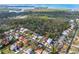 Neighborhood aerial view nestled near beautiful waterway; houses feature backyard pools and well-kept lawns at 45 Gulfwinds W Dr, Palm Harbor, FL 34683