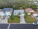 Birds eye view of a home with a well-kept lawn, palm trees and proximity to lush greenery at 45 Gulfwinds W Dr, Palm Harbor, FL 34683
