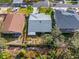 Aerial view of the property showcasing the roof, landscaping, and proximity to neighboring homes at 45 Gulfwinds W Dr, Palm Harbor, FL 34683