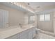 Clean bathroom with bright lighting, tile floors, a large mirror, and a shower at 45 Gulfwinds W Dr, Palm Harbor, FL 34683