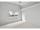 Cozy bedroom featuring a bright window, neutral walls, and carpet flooring at 45 Gulfwinds W Dr, Palm Harbor, FL 34683