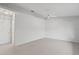 Bright bedroom featuring neutral tones, carpeting, and ceiling fan for comfort at 45 Gulfwinds W Dr, Palm Harbor, FL 34683