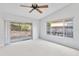 Bright and airy bedroom featuring neutral walls, carpet floors, and a slider to a patio at 45 Gulfwinds W Dr, Palm Harbor, FL 34683