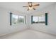 Bedroom with two windows providing ample natural light and neutral carpeting at 45 Gulfwinds W Dr, Palm Harbor, FL 34683