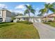 Charming one-story home with a well-manicured lawn and an attached two-car garage at 45 Gulfwinds W Dr, Palm Harbor, FL 34683