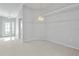 Open-concept living space featuring neutral paint, carpet flooring, and decorative lighting at 45 Gulfwinds W Dr, Palm Harbor, FL 34683