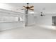 Bright living room with plush carpet, fan, and a partial view of the kitchen and breakfast bar at 45 Gulfwinds W Dr, Palm Harbor, FL 34683