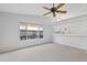 Cozy living area with neutral paint, carpet flooring, and a convenient kitchen pass-through at 45 Gulfwinds W Dr, Palm Harbor, FL 34683