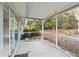 Screened-in patio overlooking a backyard with lush landscaping and mature trees at 45 Gulfwinds W Dr, Palm Harbor, FL 34683