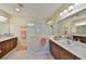 Large bathroom featuring double sinks, and a glass-enclosed shower at 4524 Deep Creek Ter, Parrish, FL 34219
