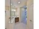 Bathroom featuring a glass-enclosed shower and tile floors at 4524 Deep Creek Ter, Parrish, FL 34219