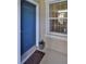 Inviting entrance with a blue door and a window with a view of the home's interior, creating a welcoming entry at 4524 Deep Creek Ter, Parrish, FL 34219