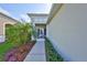 Cozy front porch with seating and plants leading to the home's entrance, providing curb appeal at 4524 Deep Creek Ter, Parrish, FL 34219