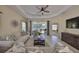 Spacious living room with comfortable sofas, tile flooring, and a seamless transition to the outdoor living space at 4524 Deep Creek Ter, Parrish, FL 34219