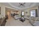 Bright living room featuring tile flooring, comfortable sofas, and an open layout flowing into the kitchen area at 4524 Deep Creek Ter, Parrish, FL 34219