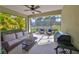 Screened in lanai featuring a ceiling fan, a grill, and plenty of wicker furniture at 4524 Deep Creek Ter, Parrish, FL 34219