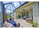 Enjoy the outdoors in this screened lanai featuring comfortable wicker furniture and grill at 4524 Deep Creek Ter, Parrish, FL 34219