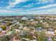 Vibrant aerial view of a residential area near the water, showcasing the area's greenery and homes at 519 Roanoke St, Dunedin, FL 34698