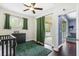 Bedroom features dark wood floors, green accents, a sliding glass door, and connected living space at 5731 French Creek Ct, Ellenton, FL 34222