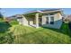Backyard featuring covered patio, lush green lawn and views of the house at 5943 Jasper Glen Dr, Lithia, FL 33547