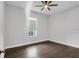 Bedroom featuring hardwood floors, a ceiling fan, and natural light from the window at 5943 Jasper Glen Dr, Lithia, FL 33547