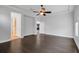 Open floor plan bedroom with hardwood floors, tray ceilings, and ceiling fan at 5943 Jasper Glen Dr, Lithia, FL 33547