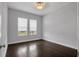 Neutral bedroom showcasing hardwood floors, bright windows, and new paint at 5943 Jasper Glen Dr, Lithia, FL 33547