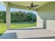 The covered patio overlooks a lawn with mature plantings for privacy at 5943 Jasper Glen Dr, Lithia, FL 33547