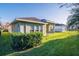 Exterior view of the house featuring lush green lawn, shrubs and well-maintained landscaping at 5943 Jasper Glen Dr, Lithia, FL 33547