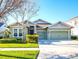 Charming single Gathering home with a well-maintained lawn, lush landscaping, and a two-car garage at 5943 Jasper Glen Dr, Lithia, FL 33547