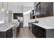 Chef's kitchen features stainless steel appliances, granite counters, dark cabinets, and a large island with bar seating at 5943 Jasper Glen Dr, Lithia, FL 33547