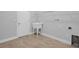 Bright laundry room with tile floor, utility sink, shelving and washer/dryer hookups at 5943 Jasper Glen Dr, Lithia, FL 33547