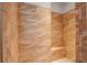 Tiled walk-in shower with built-in seat, tile surround, and mosaic tile floor at 5943 Jasper Glen Dr, Lithia, FL 33547