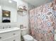 Bathroom with floral shower curtain, white vanity and view to the bedroom at 5985 38Th N Ave, St Petersburg, FL 33710