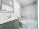 Bright bathroom featuring gray vanity, decorative tile, and tub/shower combination at 6233 Dewdrop Way # 6233, Tampa, FL 33617