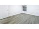 Bedroom features new wood-look floors and a window at 6233 Dewdrop Way # 6233, Tampa, FL 33617