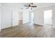 Clean bedroom features wood-look floors, white walls, a ceiling fan and multiple doorways at 6233 Dewdrop Way # 6233, Tampa, FL 33617