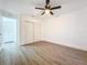 Large bedroom features wood-look floors and double-door closet at 6233 Dewdrop Way # 6233, Tampa, FL 33617