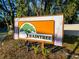 Welcome to Raintree! Community sign surrounded by trees at 6233 Dewdrop Way # 6233, Tampa, FL 33617