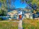 Charming two-story home with a well-maintained lawn, beautiful trees and a welcoming front entrance at 6233 Dewdrop Way # 6233, Tampa, FL 33617