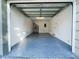 Spacious garage with epoxy flooring, offering ample storage and parking at 6233 Dewdrop Way # 6233, Tampa, FL 33617